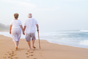 Elderly couple strolling at beach