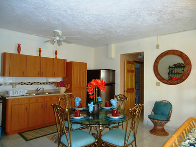 full kitchen with stainless steel refrigerator, stove, microwave, and dining set